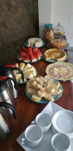 a table with many plates of food on it at Hotel Castelo La Paloma in Gamboa