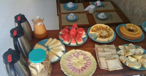 a table topped with different types of food on plates at Hotel Castelo La Paloma in Gamboa