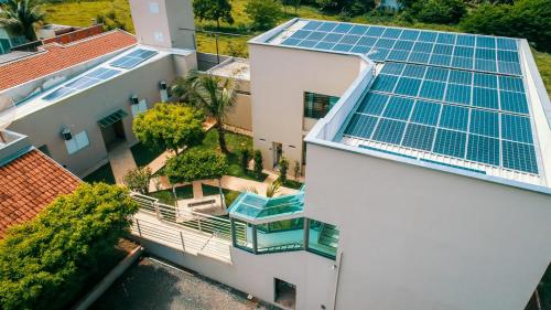 an aerial view of a house with solar panels on the roof at Hotel Winner in Barretos