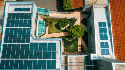 an overhead view of a building with green solar panels at Hotel Winner in Barretos