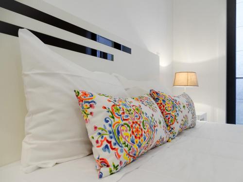 a bedroom with a white bed with two pillows at RS Porto Campanha in Porto