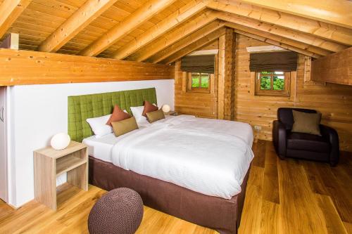 a bedroom with a large bed in a wooden cabin at Chalet am Bach in Bad Birnbach