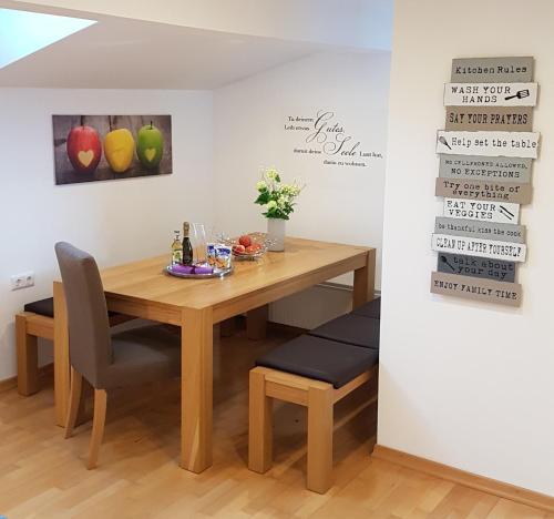 a dining room table with two chairs and a table and a table and chairsktop at Apartment Bergverliebt in Mieming