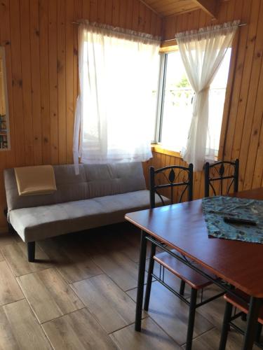 a living room with a couch and a table at Cabañas El Sol de Dichato in Dichato