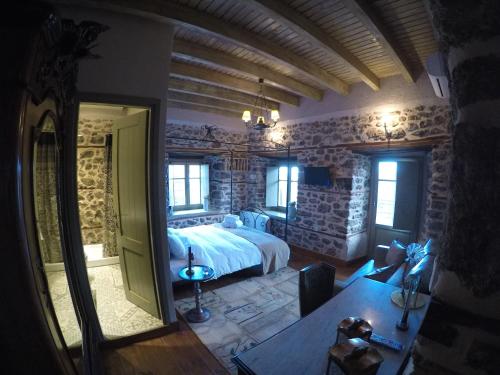 a bedroom with a bed and a table in a room at Bayiri Petit Pension in Litochoro