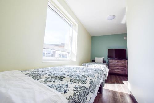 a bedroom with two beds and a window at United College in Waterloo
