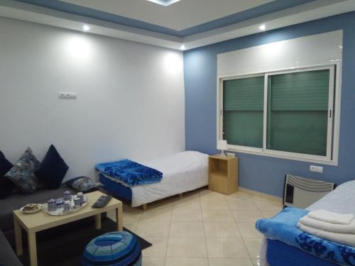 a small room with a bed and a couch at Studios Taha in Rabat
