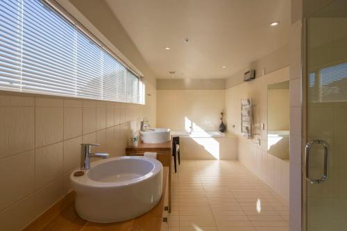 a bathroom with a sink and a toilet in it at Shotover Penthouse & Spa by Staysouth in Queenstown
