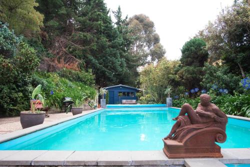a pool with a statue in the middle of it at Seahurst Apartment in Eskdale