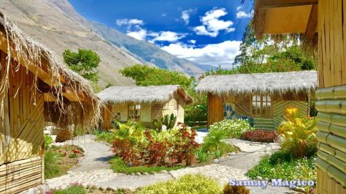 une maison avec un jardin en face d'une montagne dans l'établissement Cabañas Samay Mágico Ecolodge, à Huigra