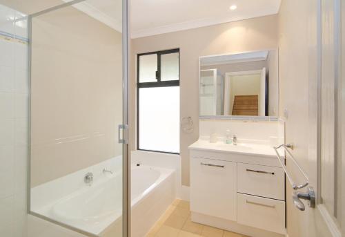 a bathroom with a shower and a sink and a bath tub at Tranquility in Yallingup