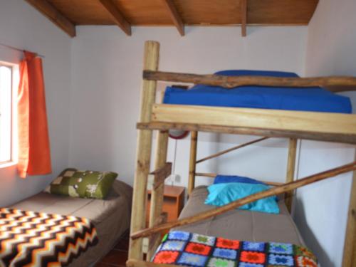 a bedroom with two bunk beds in a room at Cabaña Laynaturi in San Pedro de Atacama