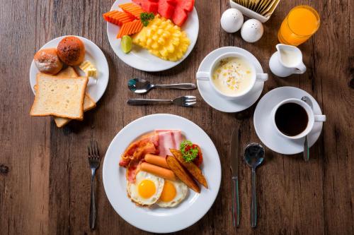 a table with plates of breakfast foods and a cup of coffee at ibis Styles Bangkok Sukhumvit Phra Khanong in Bangkok