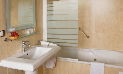 a bathroom with a white sink and a mirror at Hotel Celta in A Guarda