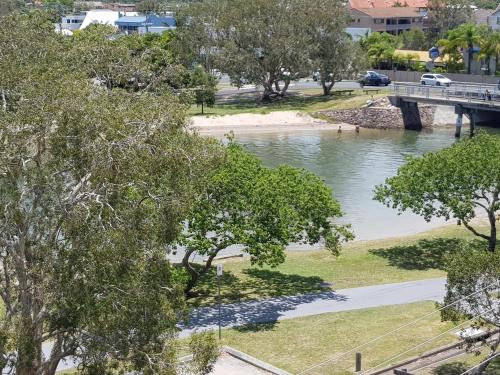 a view of a river with a bridge and trees at Excellsior Apartments in Mooloolaba