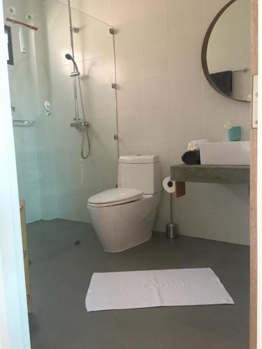 a bathroom with a toilet and a sink and a mirror at Baan Andaman Sea Surf in Patong Beach