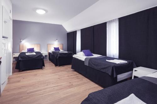 a room with three beds in a room at Vuokatti Sport Resort in Vuokatti