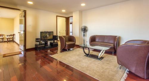 a room with chairs and a television and a hair salon at Swayambhu Hotels & Apartments- Sitapaila in Kathmandu
