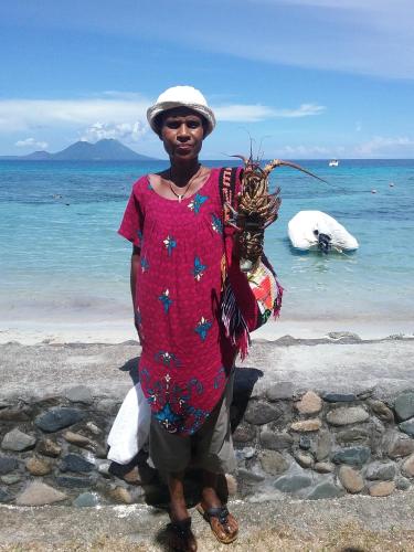 a woman standing on the beach near the ocean at Rapopo Plantation Resort in Kokopo