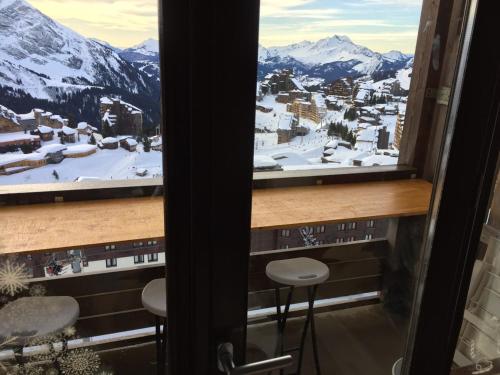 a view of a snowy mountain from a window at F2 résidence Antarès in Avoriaz