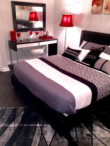 a bedroom with a large bed and a desk at Premier National Harbor House in Fort Washington
