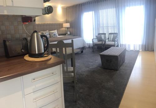 a kitchen and living room with a bedroom and a bed at Se La Vie Guest Suite in Big Bay