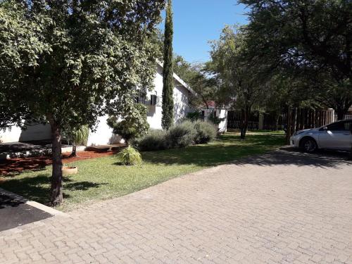 a brick driveway in front of a house at Airport Hotel in Kimberley