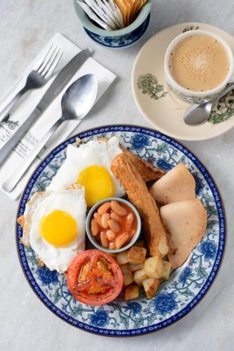 a blue and white plate of food with eggs and toast at Noordin Mews in George Town