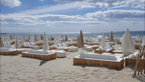 een strand met stoelen en parasols en de oceaan bij Exceptionnel ! Appartement vue imprenable sur mer. in Carnon-Plage