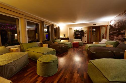 a large living room with couches and chairs at Gran Baita Hotel & Wellness in Courmayeur
