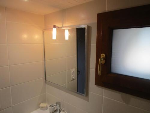 a bathroom with a television and a bathroom sink at Fouettara in Firminy