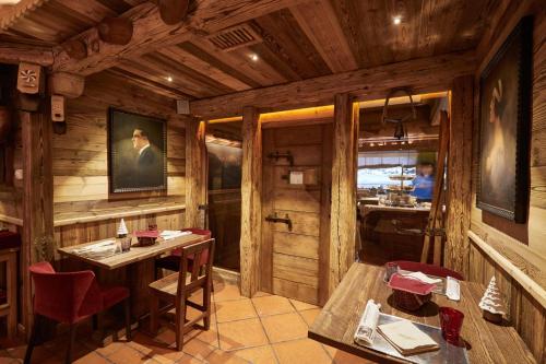 a dining room with wooden walls and a table and chairs at Gran Baita Hotel & Wellness in Courmayeur