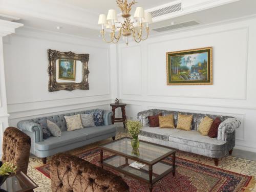 a living room with two couches and a table at Dhavara Boutique Hotel in Vientiane