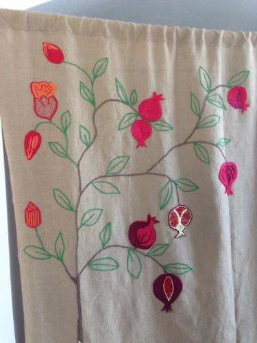 a towel with a tree with flowers and pomegranates at Albergo Diffuso Il Casale in Ginosa