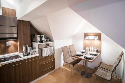 a kitchen with a table and chairs in a room at Horský apartmán Špindlerův Mlýn in Krausovy Boudy