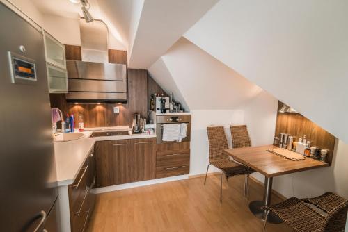 a kitchen with a wooden table and a kitchen with a sink at Horský apartmán Špindlerův Mlýn in Krausovy Boudy