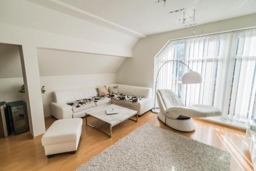 a living room with a white couch and a table at Horský apartmán Špindlerův Mlýn in Krausovy Boudy