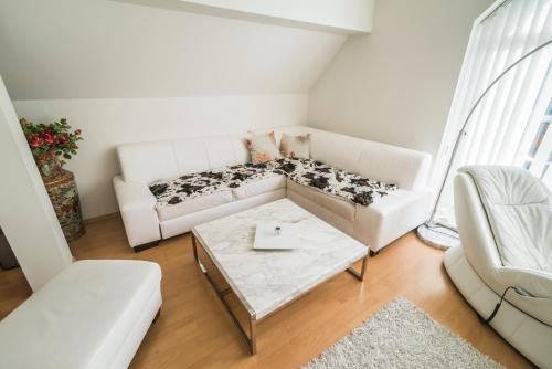 a living room with a white couch and a table at Horský apartmán Špindlerův Mlýn in Krausovy Boudy