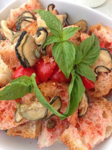a plate of food with vegetables and basil on it at Albergo Diffuso Il Casale in Ginosa
