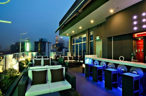 a balcony with chairs and a bar on a building at The Seacare Hotel in Singapore
