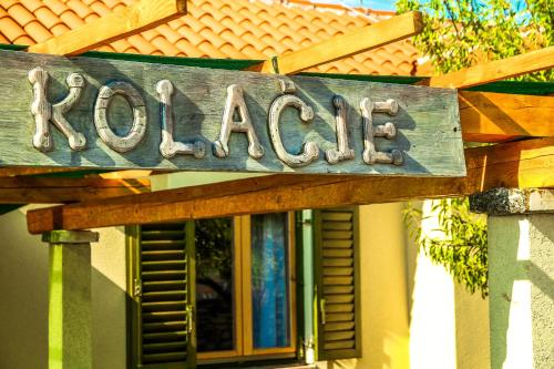 a wooden sign that reads ranch on a house at Villa Kolacje in Škrip