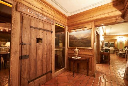 a room with wooden walls and a wooden door at Gran Baita Hotel & Wellness in Courmayeur
