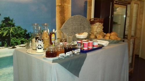 a white table with food and drinks on it at Gästehaus Moselblick in Trittenheim