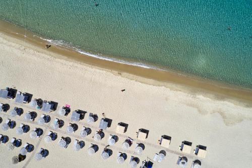 an overhead view of a beach with chairs and the ocean at Dionysos Seaside Resort Ios in Mylopotas