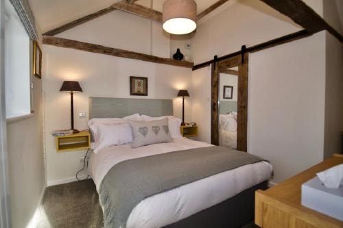 a bedroom with a large bed in a room at Fazeboon Cottages in Chillesford