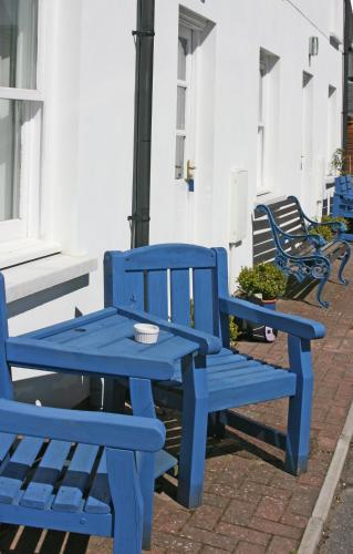 a blue picnic table and bench next to a building at The Gremlin Lodge in Brecon