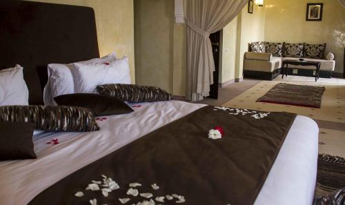 a bedroom with a bed with flowers on it at Kasbah ATFEL in Ourika