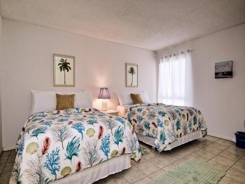 a bedroom with two beds and a window at 440 West Condo 1604N in Clearwater Beach