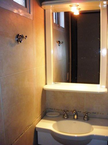 a bathroom with a sink and a mirror at Casas De Pinamar in Pinamar