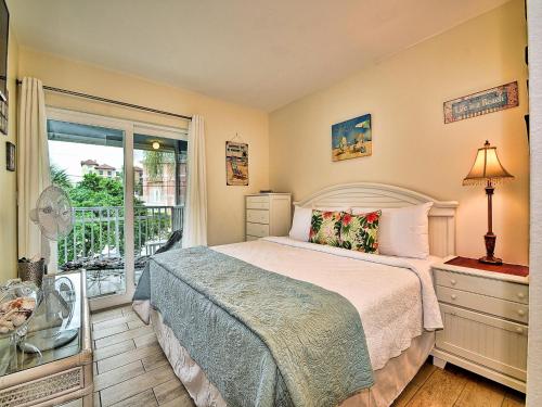 a bedroom with a bed and a large window at Gone Beaching 202 in Clearwater Beach